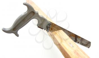 Hacksaw in sawed yellow wooden board on white background