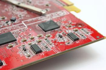 Electronic payment of a video card of red color with radio components and microcircuits.