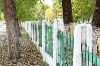 green fence autumn park