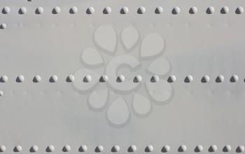 A silver painted metal aircraft background  with  rivets.