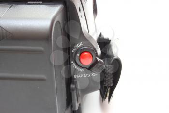 Black videocamera with buttons and switches on a white background