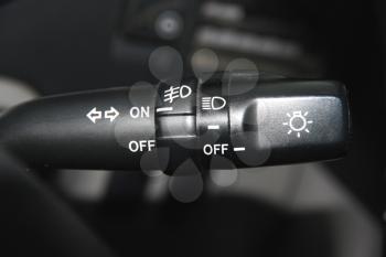 The switch of turn and light of headlights of the car on a wheel