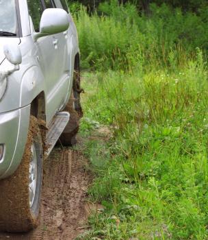 Extreme offroad behind an unrecognizable car in mud
