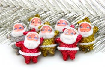 Some dolls of Santa Claus are together isolated on a white background