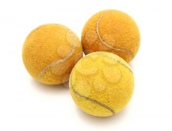Three old tennis balls on a white background