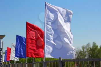 colored flags on a blue sky background