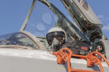 Military pilot in the cockpit of a jet aircraft.