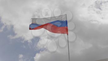 Russian flag on the flagpole waving in the wind against a blue sky with clouds. Slow motion.