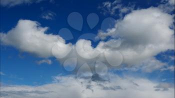 Time lapse Fluffy clouds float across the blue sky. UltraHD stock footage.