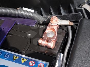 Copper battery terminal of a car close-up.