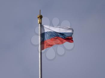 Russian flag fluttering in the wind on a flagpole.