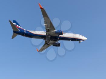 MOSCOW , RUSSIA, June 10, 2019: The Commercial passenger airplane flying overhead on sunny day on June 10, 2019 in Moscow, Russia.