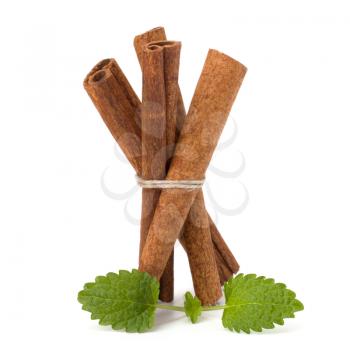 Cinnamon sticks and fresh bergamot mint leaf isolated on white background