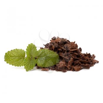Crushed chocolate shavings pile and mint leaf isolated on white background