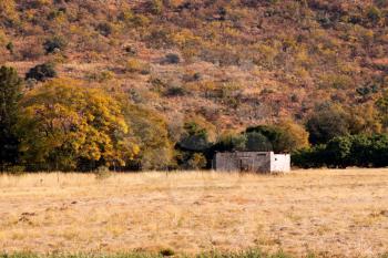 Royalty Free Photo of a Small Abandoned Shack Near the Mountains