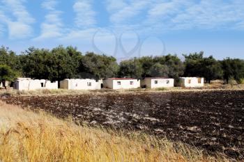Royalty Free Photo of Ruins of Farm Workers Houses Next to Plowed Land