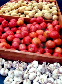 Royalty Free Photo of Garlic, Potatoes and Tomatoes in Vegetable Stands