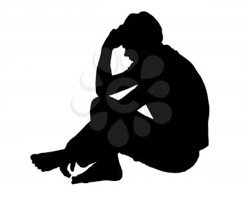 Side profile portrait silhouette of a depressed teenage boy sitting on ground thinking 
