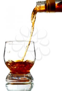 alcohol drink pouring into glass isolated on white background