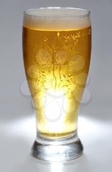 beer is in glass grey background