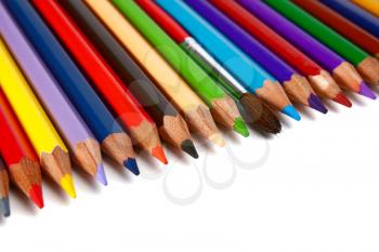 crayons coloured pencils and brush for paints isolated on white background