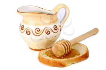 honey in a jug and loaf on white background