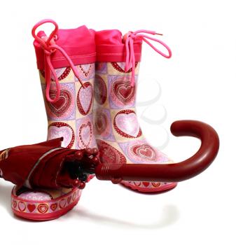 pink rubber knee-boots and umbrella isolated on white background