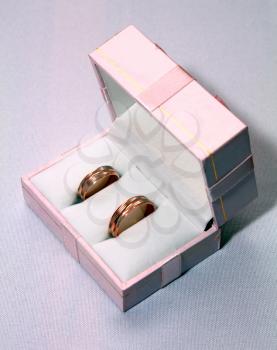 two wedding rings in pink box isolated on white background