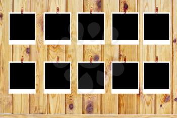 set of ten old blank polaroids frames lying on a wood surface 