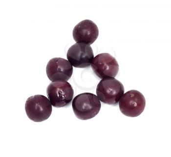 a triangle of black cherries on a white background