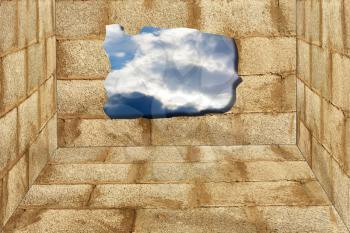  blue sky hole in aged brick wall background 
