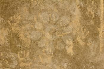 prints of children's hands on a background of concrete