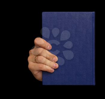 blue book in hand on a black background