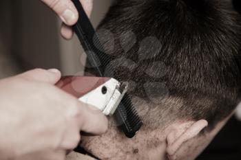 Barber cutting hair with clipper - a series of BARBER images.