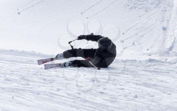 The skier fell in the snow at speed .