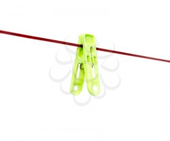 Green clothespin on a rope on a white background