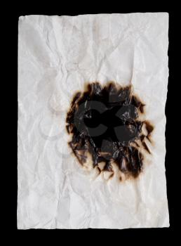 burnt crumpled white paper on black background