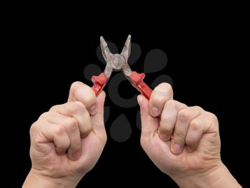 pliers in hand on a black background