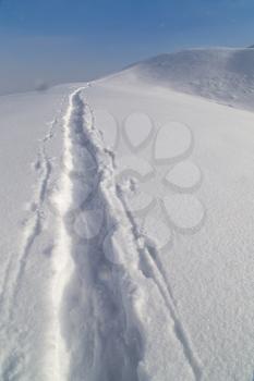 Trail in the snow in the mountains