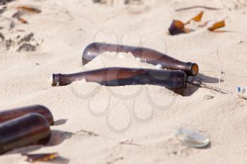 Glass bottles in the sand on nature. trash