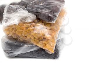 black and yellow raisins in a plastic bag