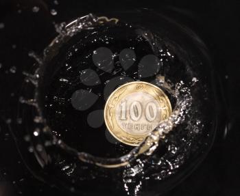 coins in water splashes on a black background