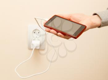 cell phone charging in your hand