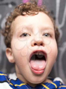 portrait of a boy showing tongue