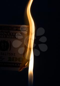 100 dollars burning on a black background