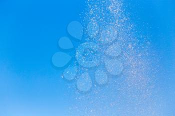 water splashing from the fountain in the background of blue sky