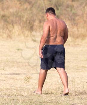 fat man in shorts outdoors