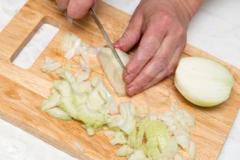 Cook chopped onion on the board