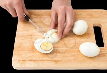 cook eggs on cutting board on a black background
