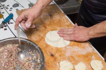 man prepares dumplings at home